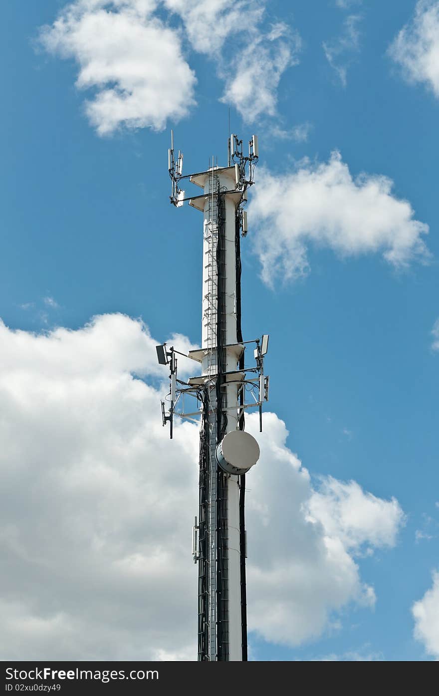 White Antenna Tower with Blue Sky and Clouds