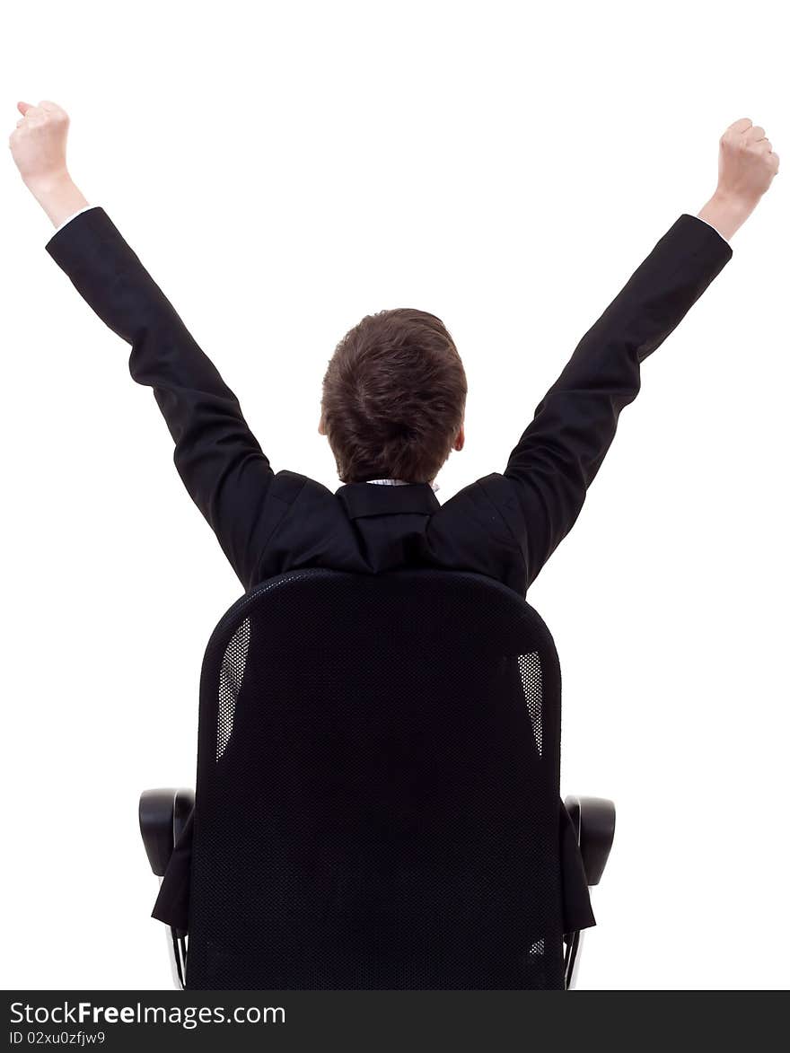 Bac picture of a business woman sitting in a chair and with her hands in the air celebrating success