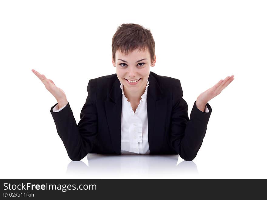 Young beautiful business woman behind the desk with open arms, isolated