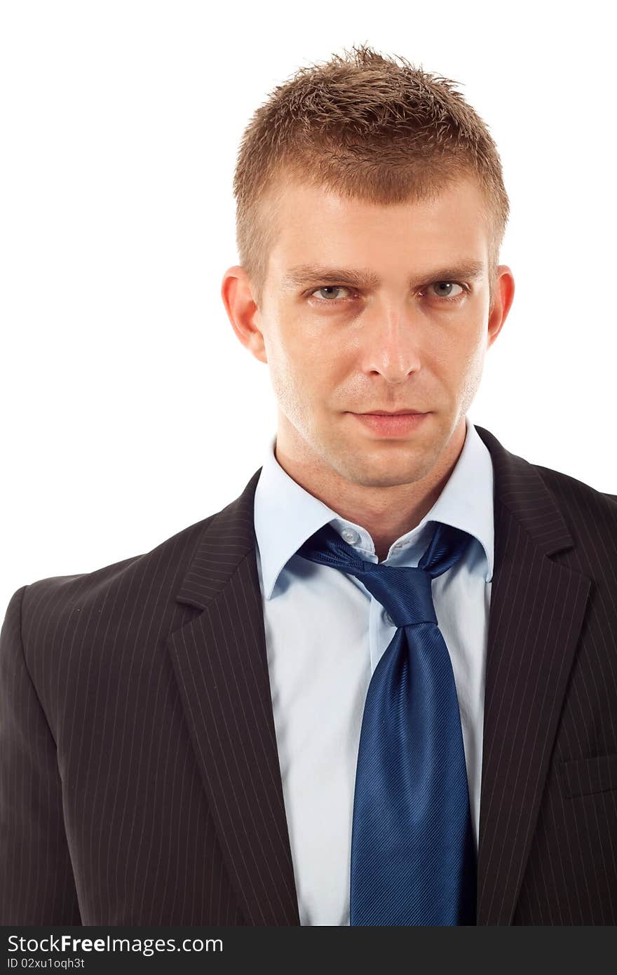 Portrait of a handsome young businessman staring against isolated white background