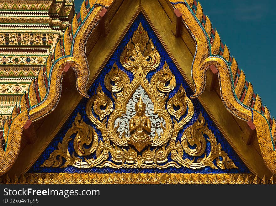 Buddhist angel at the triangular end of the temple roof. Buddhist angel at the triangular end of the temple roof