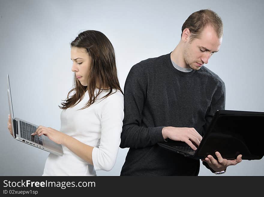 White man and woman studying internet on computers. White man and woman studying internet on computers