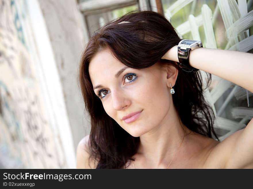 Young attractive woman near the wall with graffiti