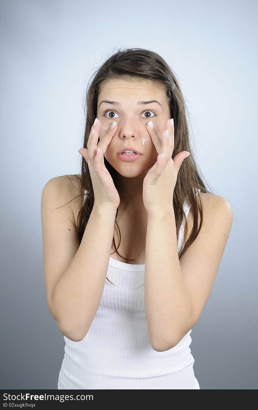 White adult treating her face. White adult treating her face