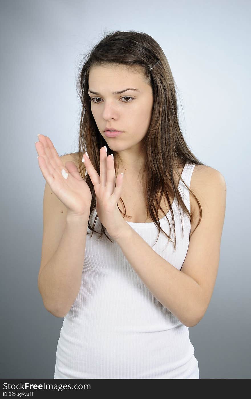 White adult treating her hands. White adult treating her hands