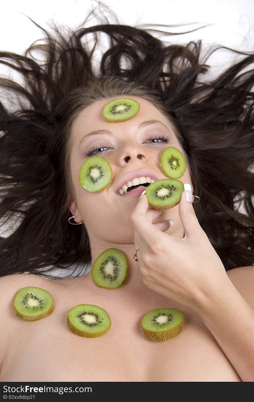 Young girl with citrus fruits on white background