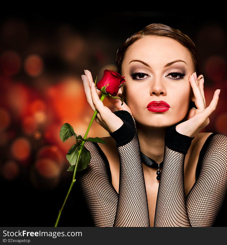 Beauty girl with rose against an abstract dark background. Beauty girl with rose against an abstract dark background