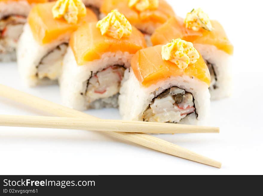 Sushi with sticks on a white background close up