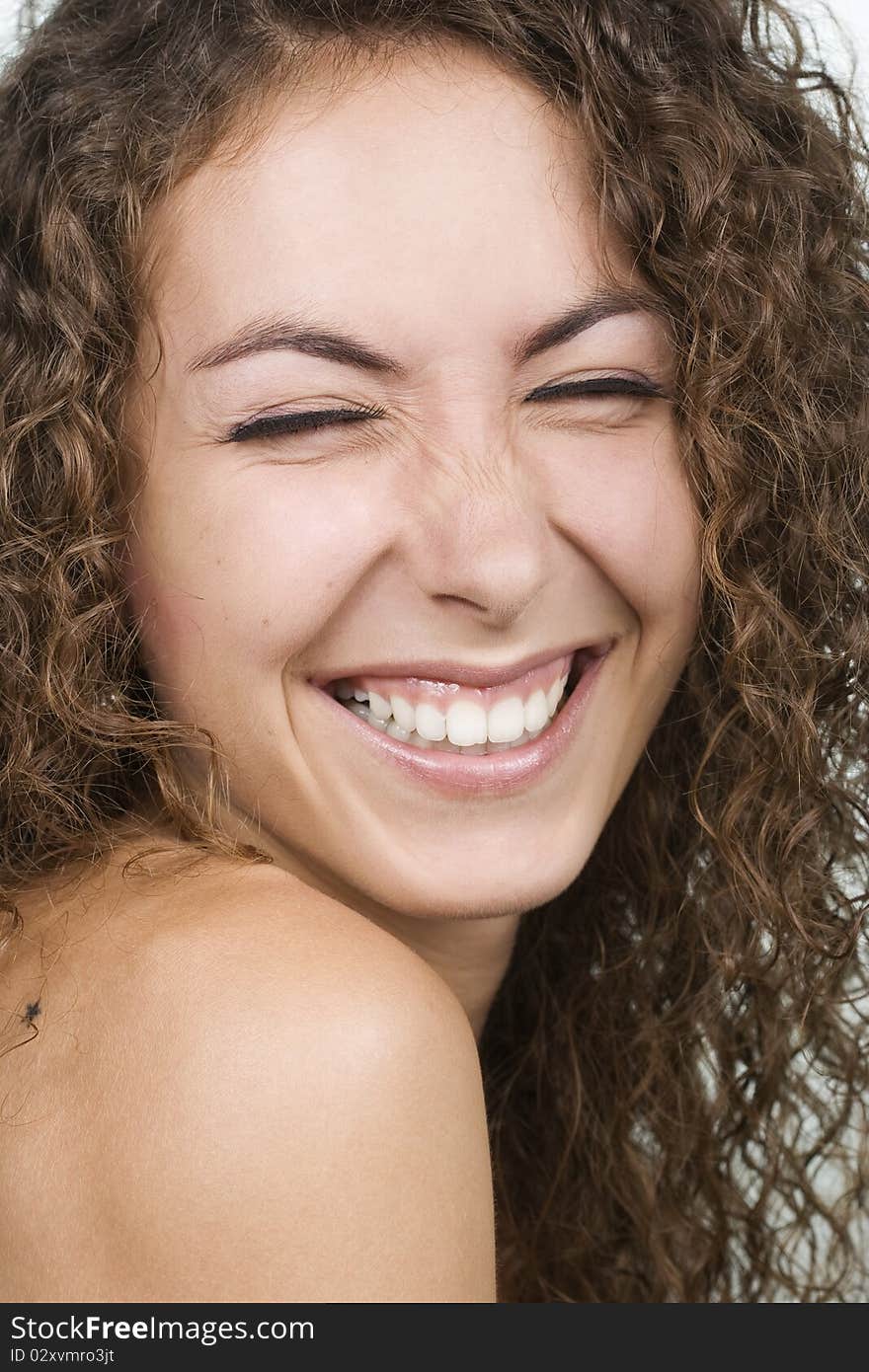 Beautiful young curly cheerful girl laughing. Beautiful young curly cheerful girl laughing