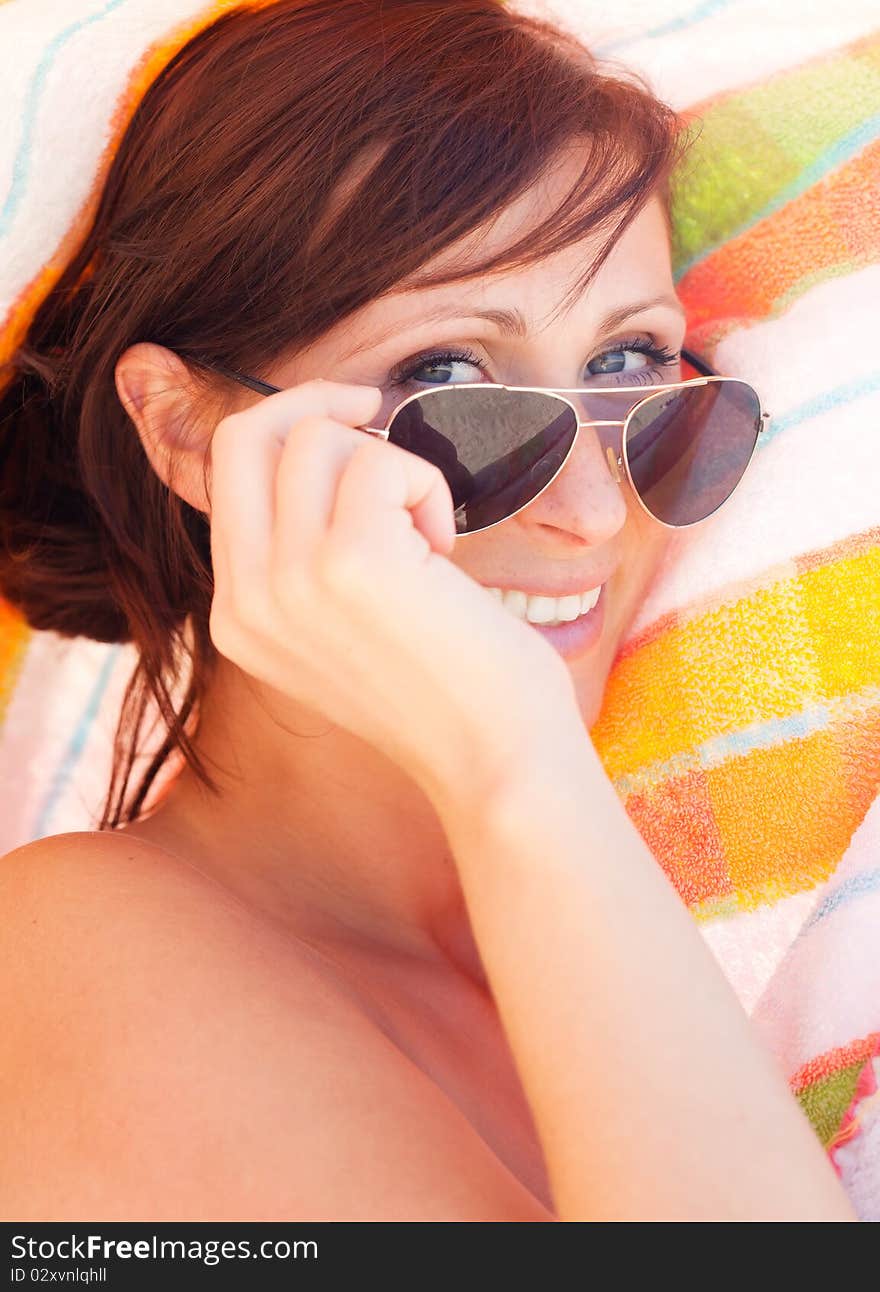 Happy female with towel on the beach playing. Happy female with towel on the beach playing