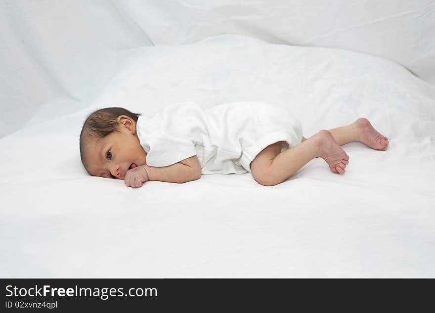 Newborn baby girl laying on her tummy. Newborn baby girl laying on her tummy