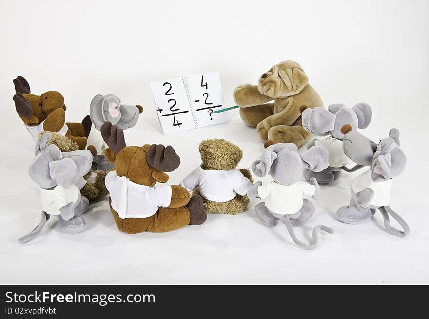 This image shows several stuffed animals in math class. This image shows several stuffed animals in math class