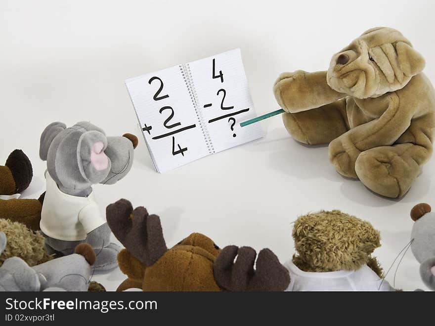 This image shows several stuffed animals in math class. This image shows several stuffed animals in math class