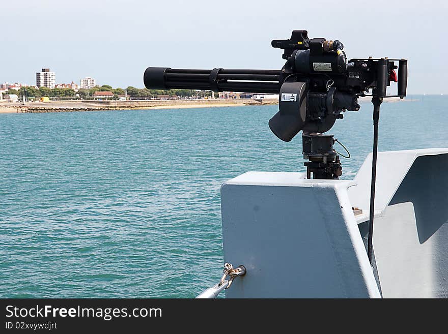 A Royal Navy Mini Gun mounted on the side of a Royal Naval Minehunter Class ship