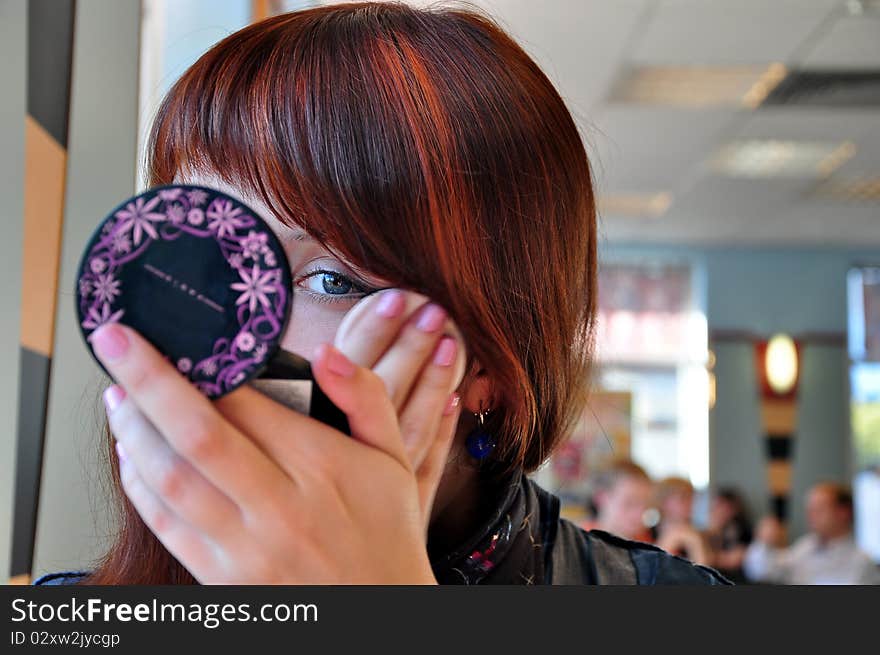 The young girl puts make-up. The young girl puts make-up