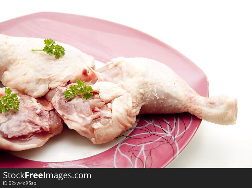 Chicken thigh raw with parsley and onto plates. Chicken thigh raw with parsley and onto plates