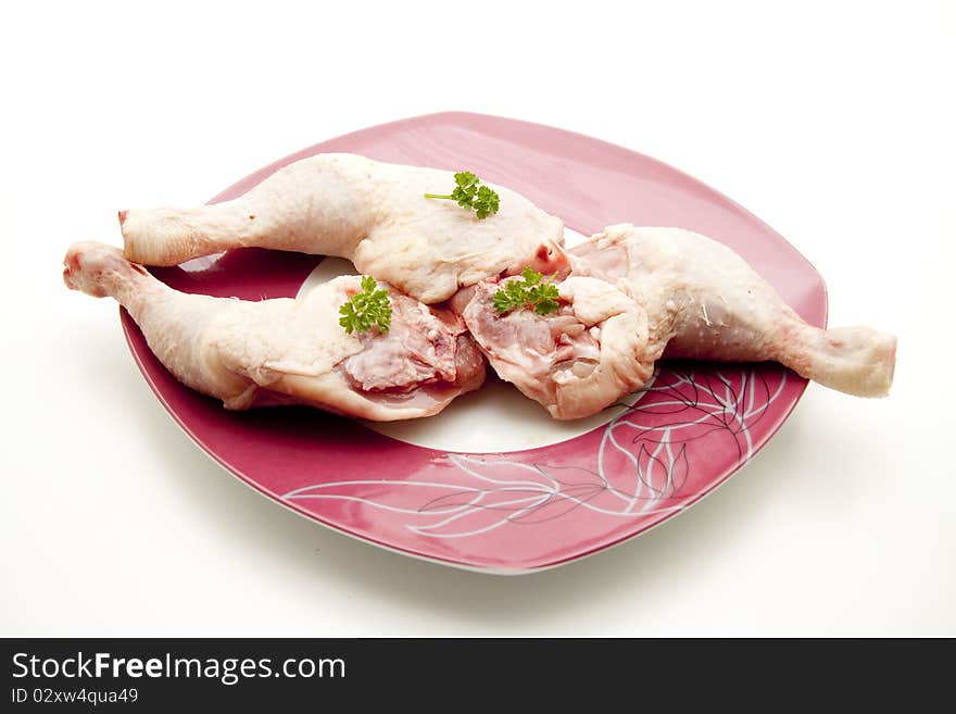 Chicken thigh raw with parsley and onto plates