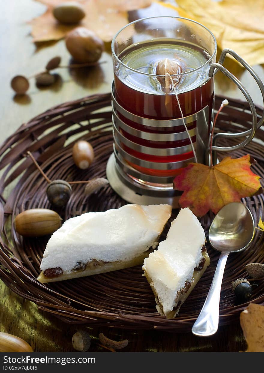 Cake with raisins in a basket with tea in the background. Cake with raisins in a basket with tea in the background