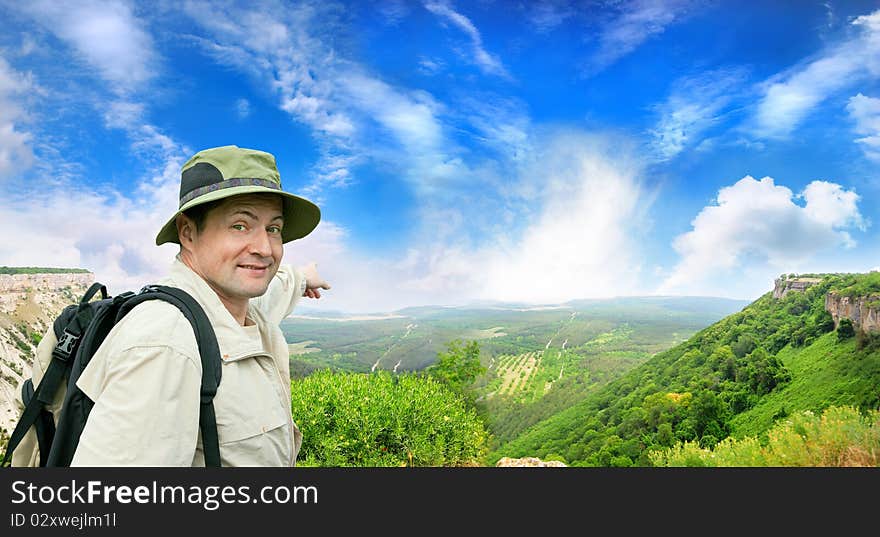 Brisk tourist shows the direction on a country road. Brisk tourist shows the direction on a country road