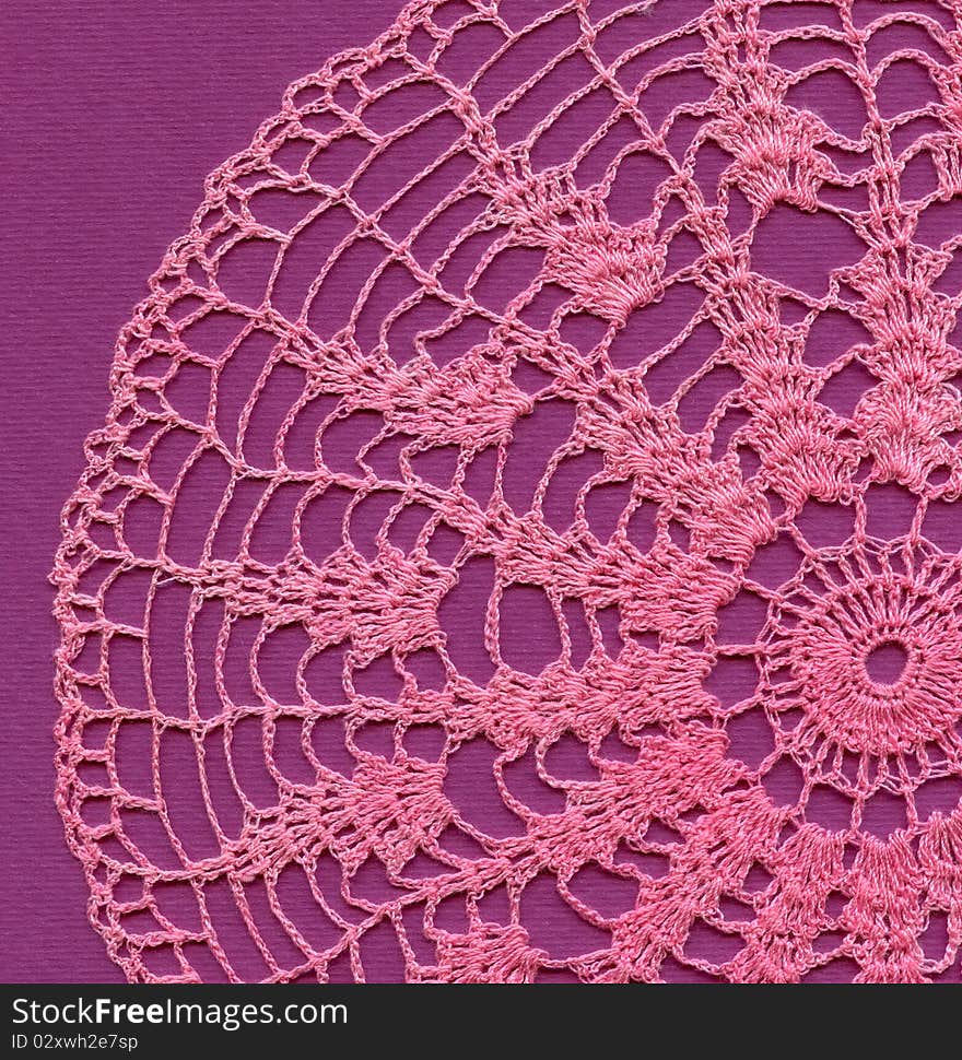 Pink knitted napkin and violet background