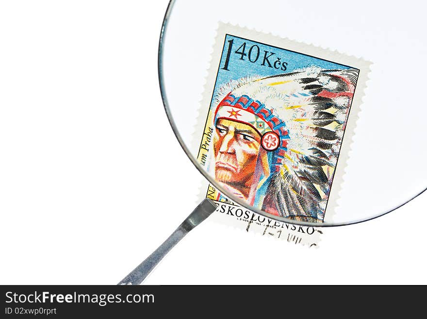 Postage stamp under magnifier with tweezers