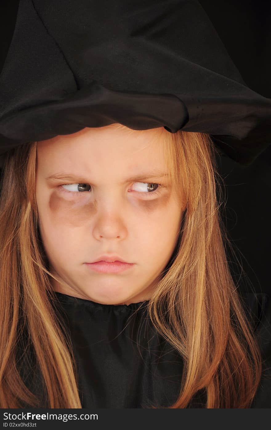 Girl disguised as a witch for Halloween