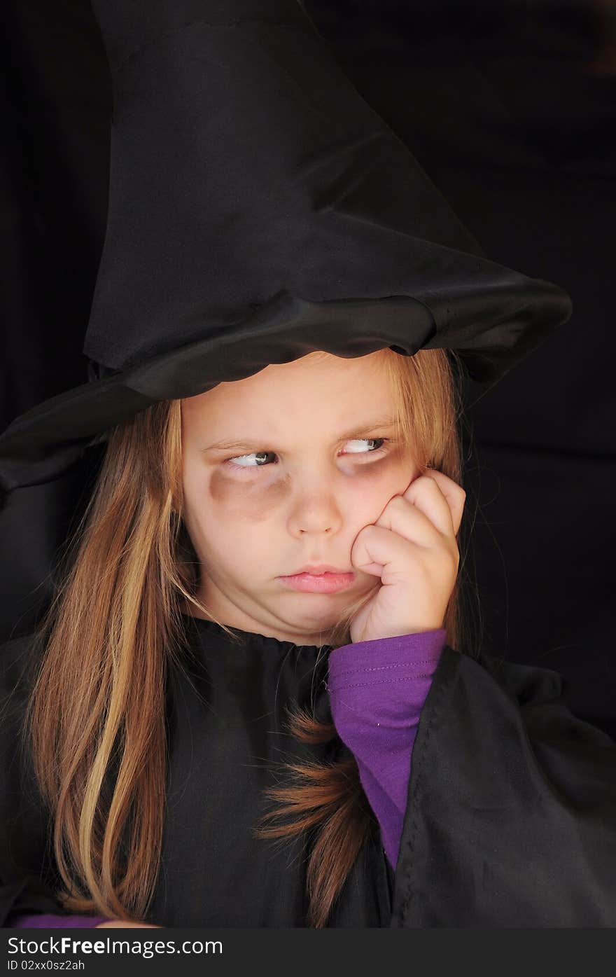 Girl disguised as a witch for Halloween