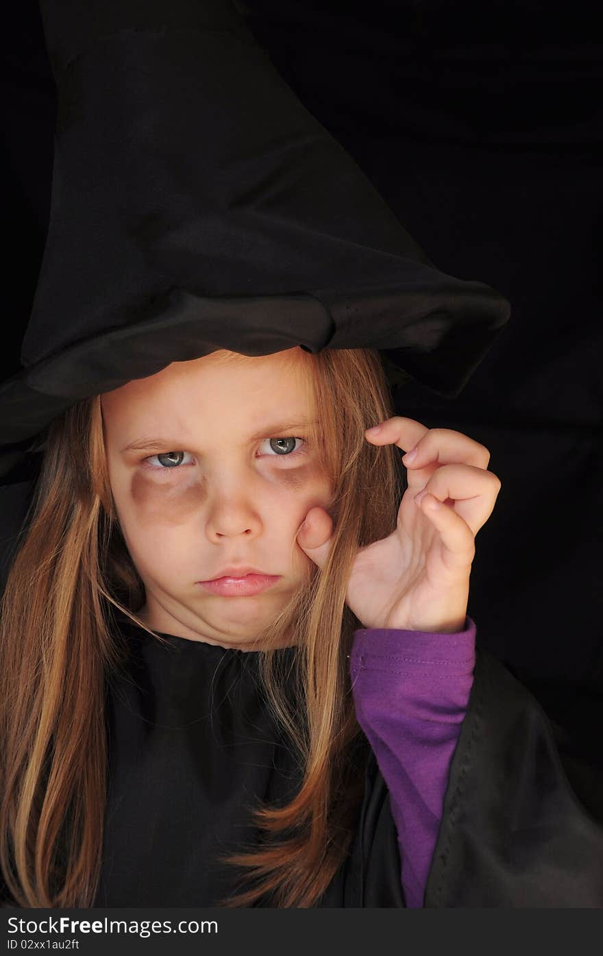 Girl disguised as a witch for Halloween