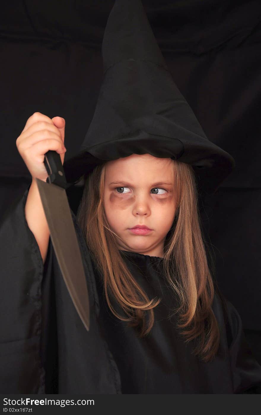 Girl disguised as a witch for Halloween