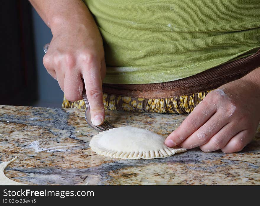 Enhancing raw Pierogi with fork. Enhancing raw Pierogi with fork