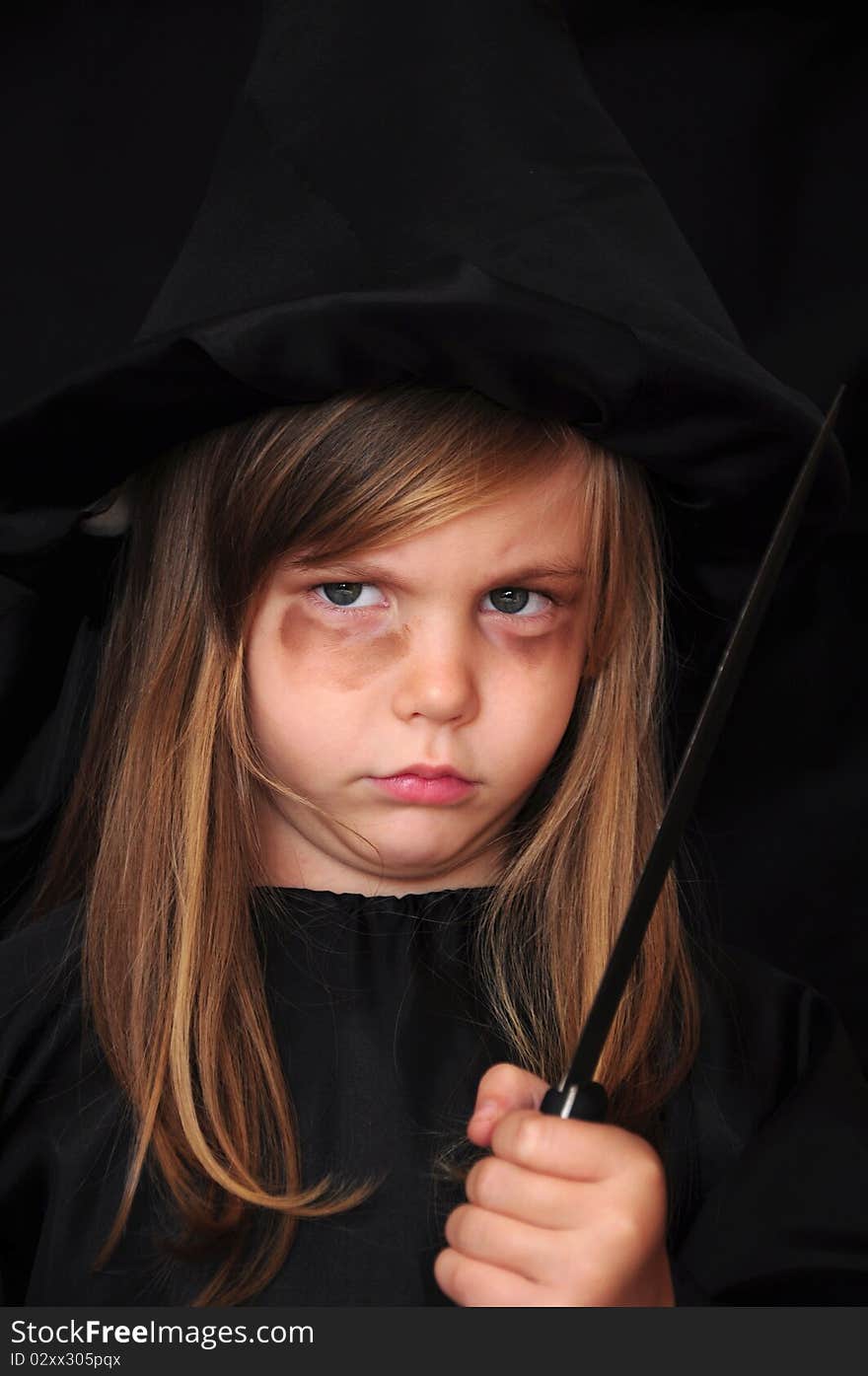 Girl disguised as a witch for Halloween