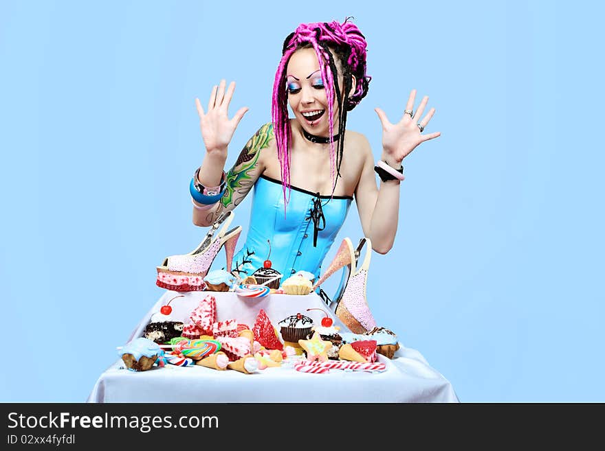 Portrait of a trendy girl with great number of sweets. Portrait of a trendy girl with great number of sweets.