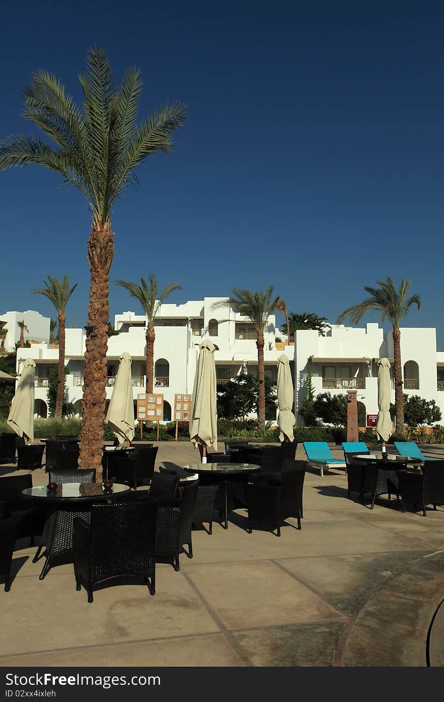 Empty cafe with chairs and tables standing outdoor. Empty cafe with chairs and tables standing outdoor.