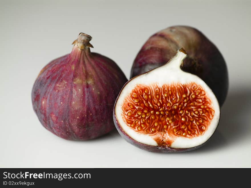 Closeup of three figs on a table