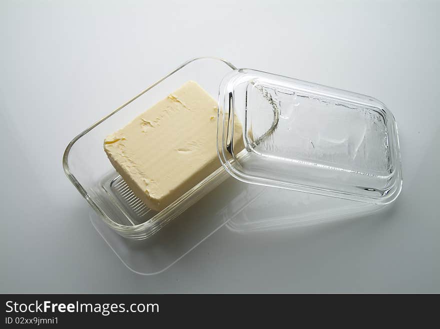 Butter in a buterdish made of glass on a table