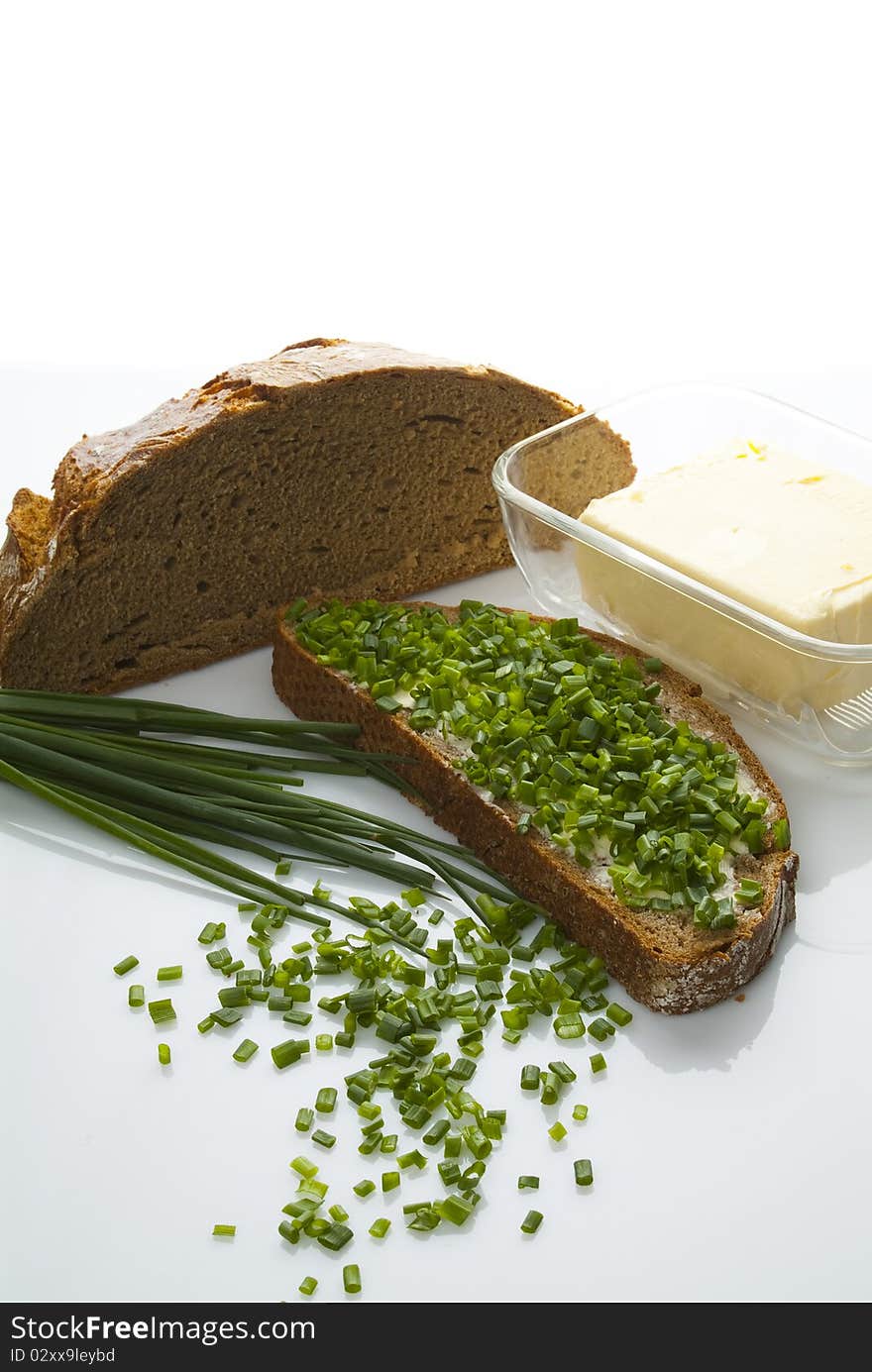 Bread butter and chives on a table