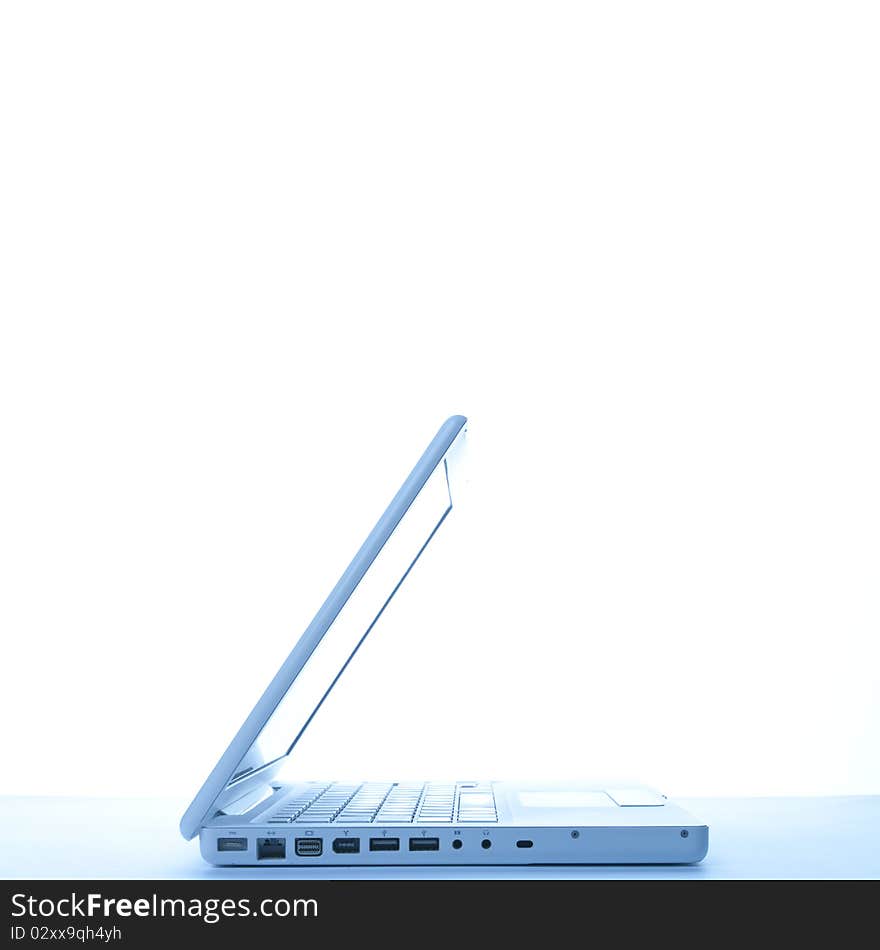 Laptop on table arranged before white background