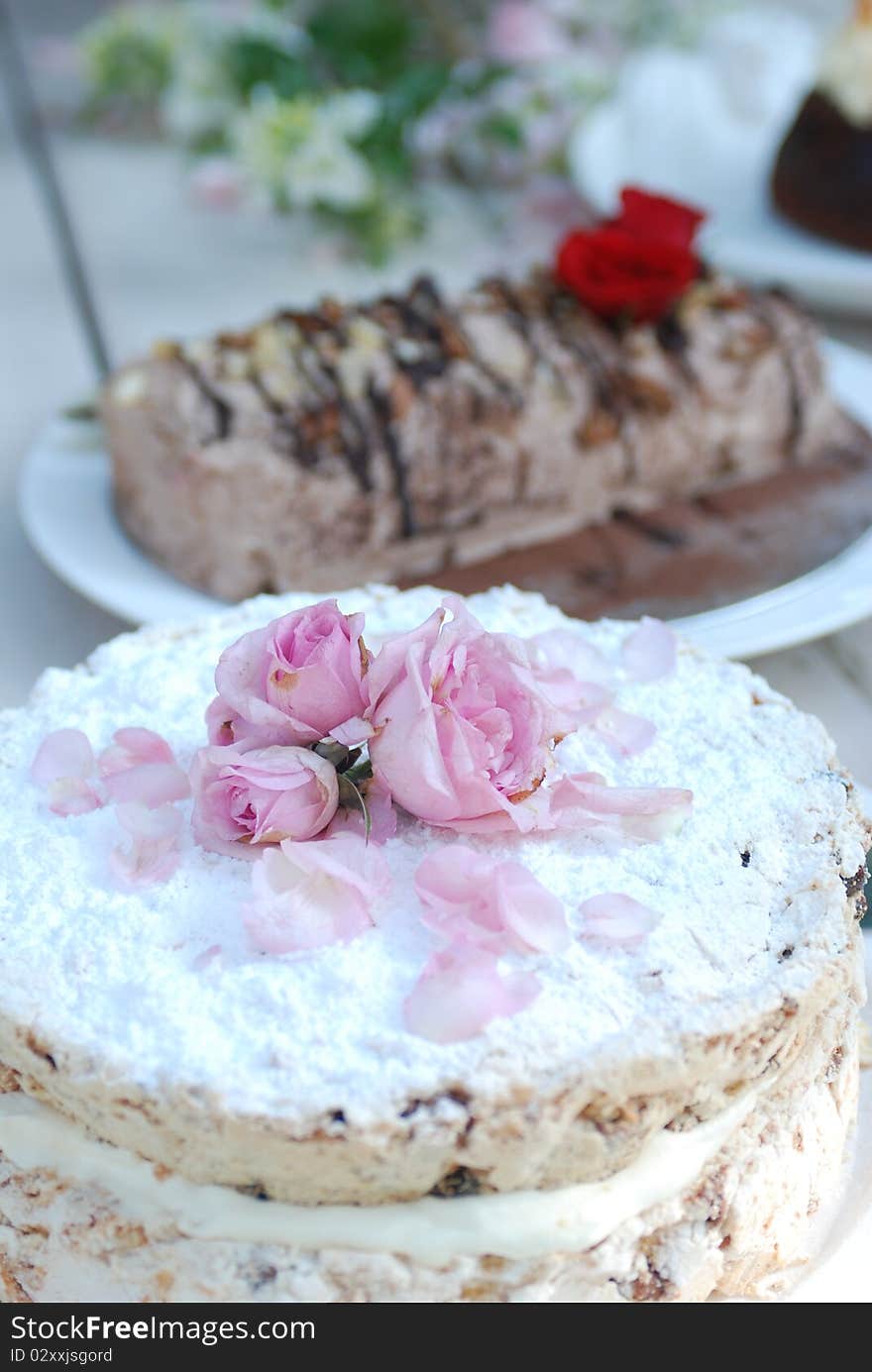 Cakes sit on a table ready to be served to guests. Cakes sit on a table ready to be served to guests