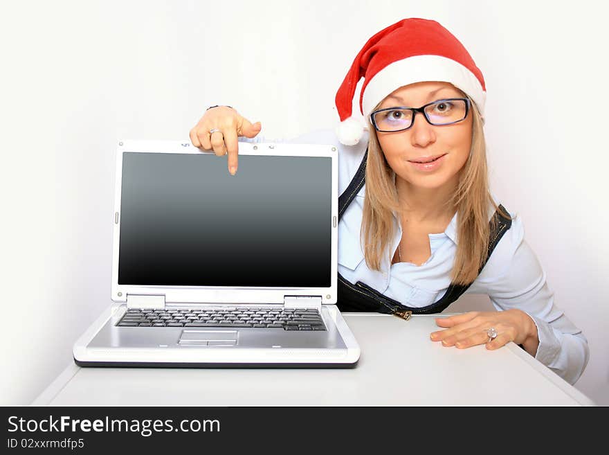 Portrait of a young businesswoman with a red Santa hat