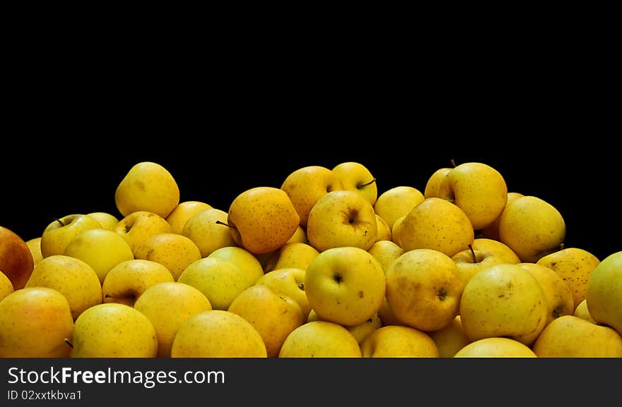 Apples of the Golden variety for sale. On black background. Apples of the Golden variety for sale. On black background.