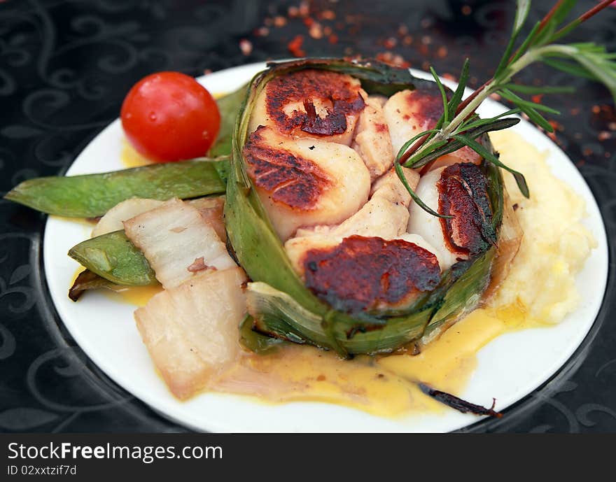 Baked scallops tatin (cooked upside down) held together with leek leaves.