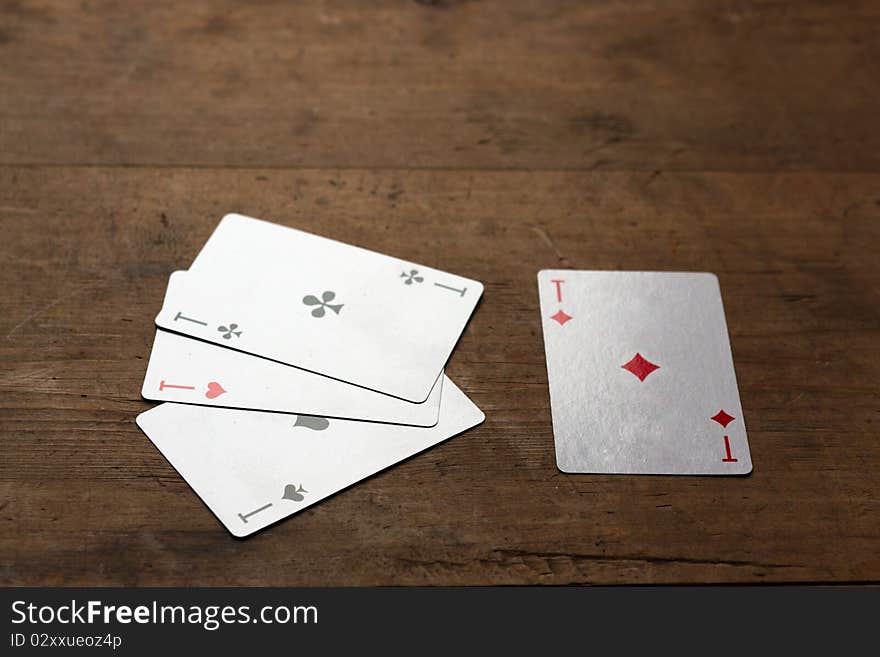 Four ases on old wooden table