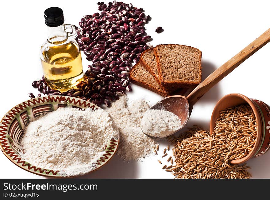 Butter, flour, beans, wheat, oats, bread isolated on a white background. Butter, flour, beans, wheat, oats, bread isolated on a white background