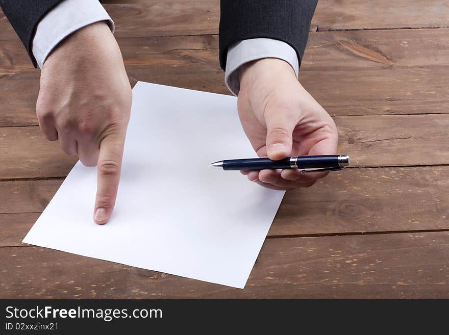 Part of hands signing a contract. Part of hands signing a contract