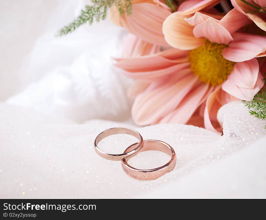 Closeup of wedding rings and flowers