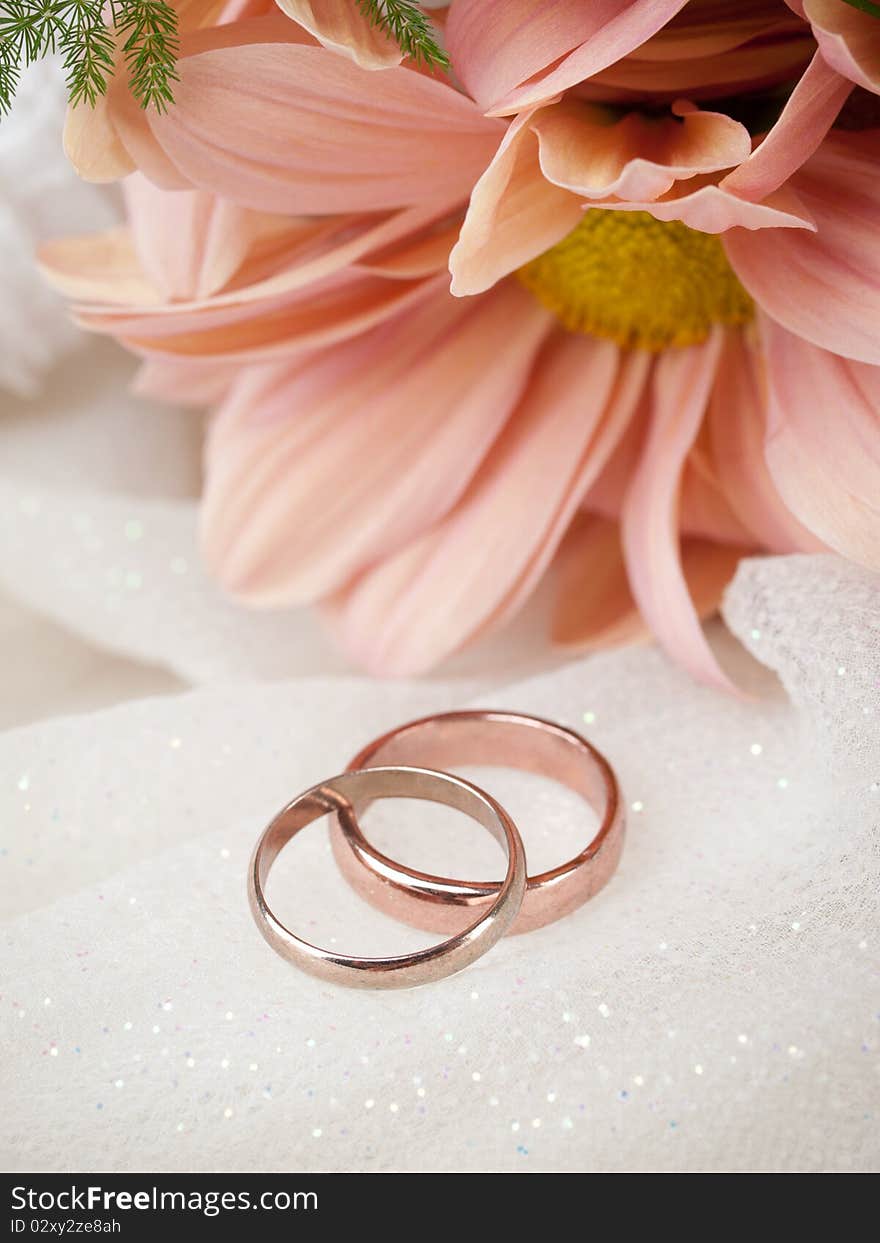 Closeup of wedding rings and flowers