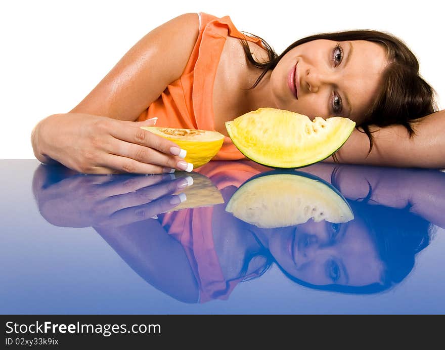 Beautiful young girl sitting in a blue desk. Accompanied by fruit girl