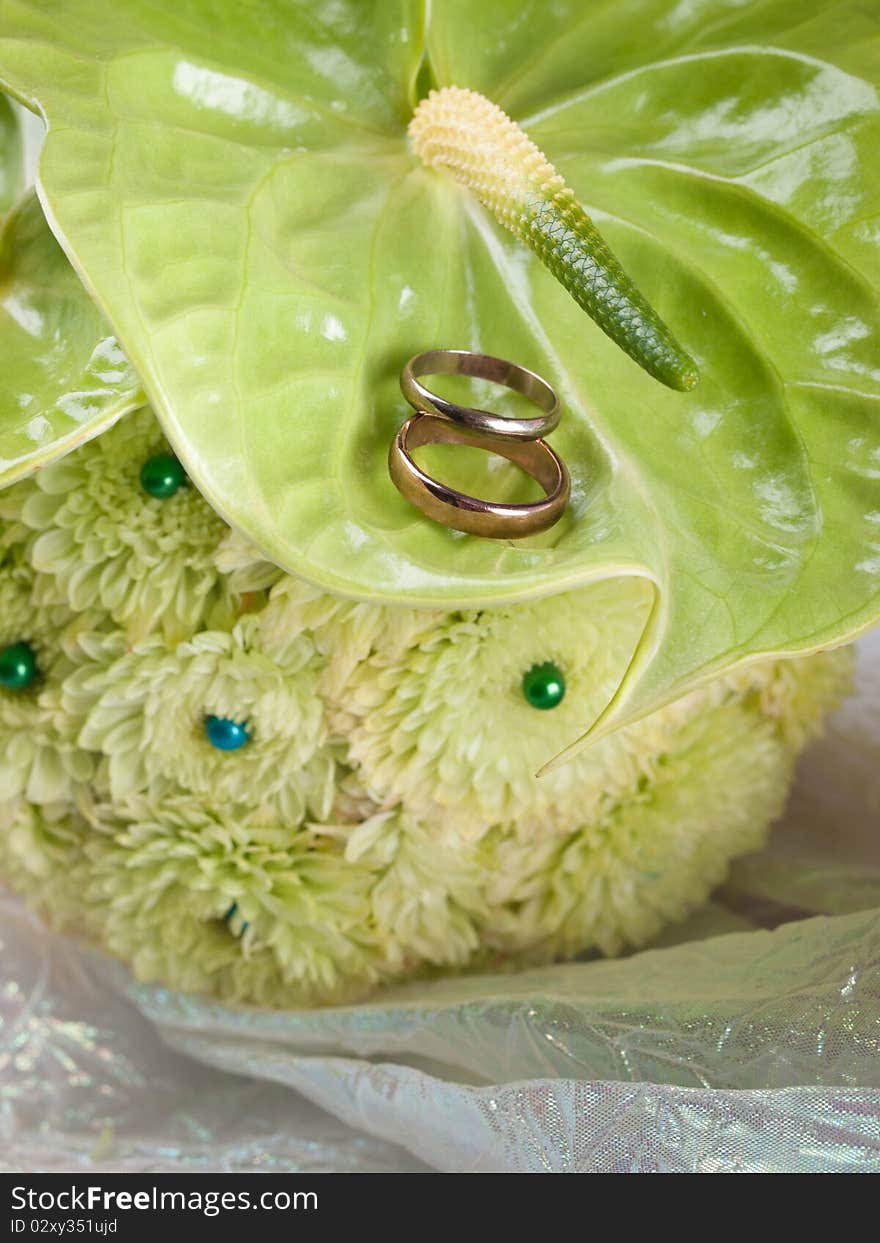 Closeup of wedding rings and flowers