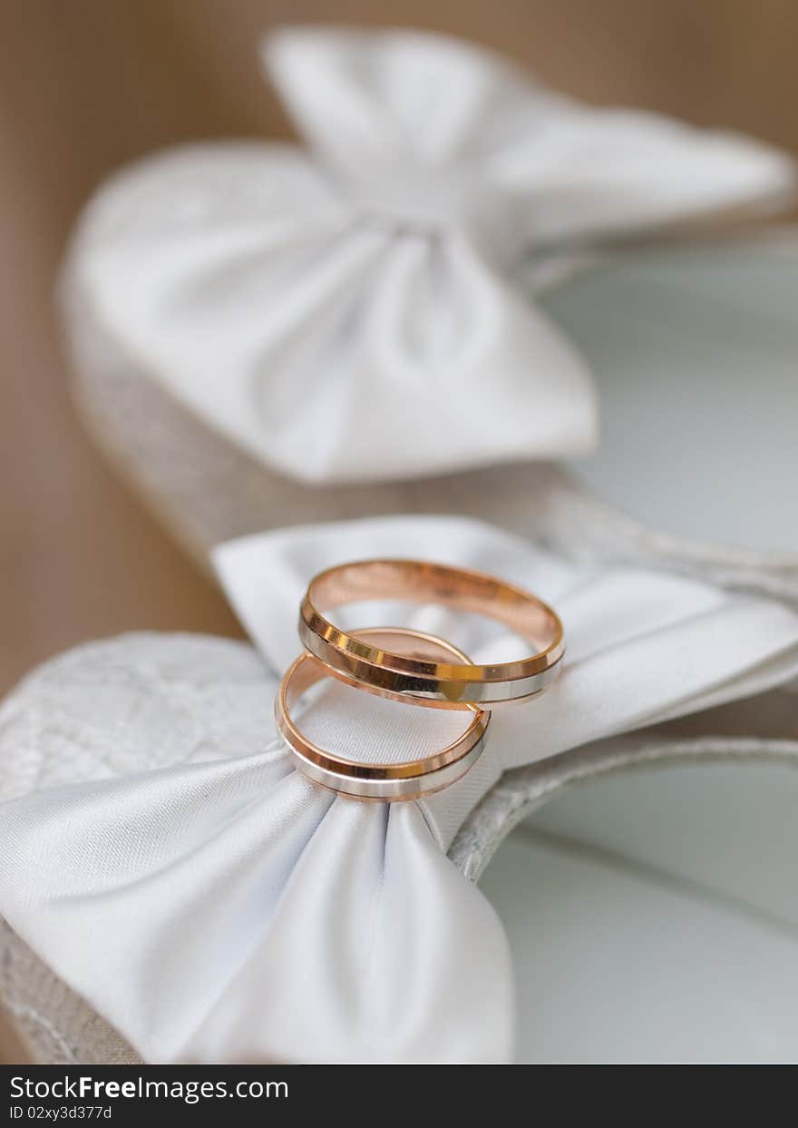 Closeup of wedding rings on a white shoes. Closeup of wedding rings on a white shoes