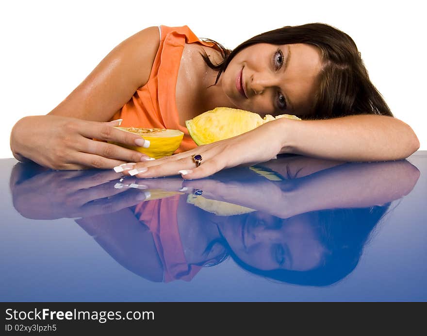 Beautiful young girl sitting in a blue desk. Accompanied by fruit girl